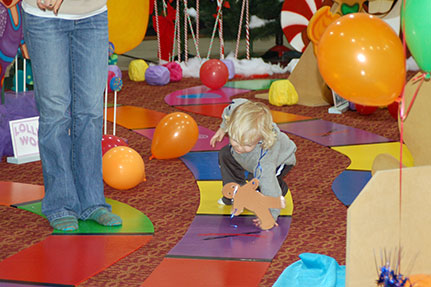 Little Boy Playing on the Life-Sized Candy Land Bo